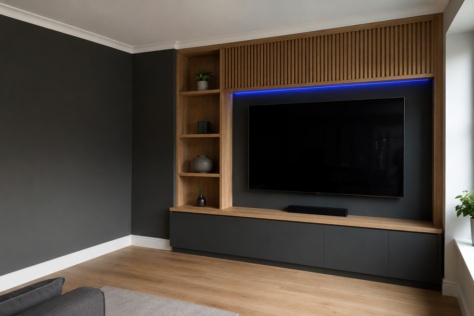 Contemporary fitted media wall with oak slat detailing and dark cabinetry